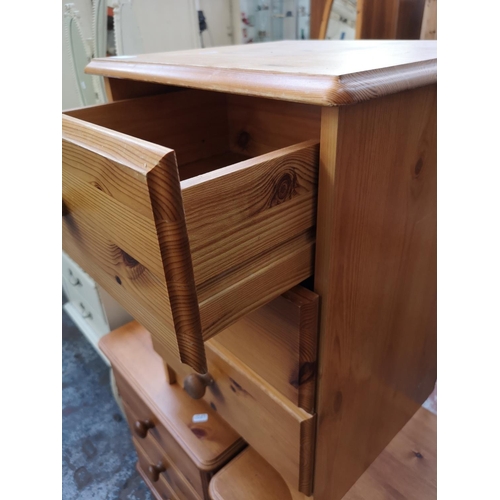 423 - Three modern pine bedside chests of three drawers