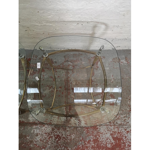 424 - A pair of brass and chrome plated side tables, both having bevelled glass tops and swan design - app... 