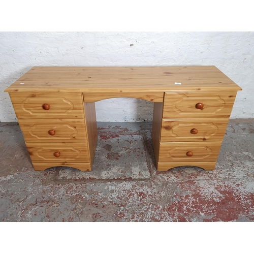 429 - A modern pine effect dressing table with six drawers - approx. 69cm high x 142cm wide x 44cm deep