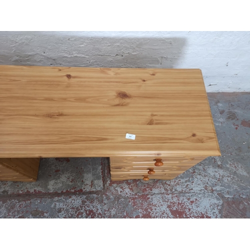 429 - A modern pine effect dressing table with six drawers - approx. 69cm high x 142cm wide x 44cm deep