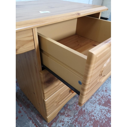 429 - A modern pine effect dressing table with six drawers - approx. 69cm high x 142cm wide x 44cm deep