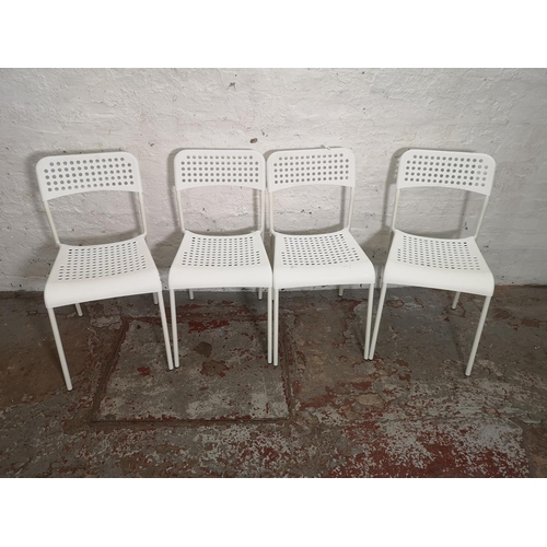 431 - A set of four IKEA Adde white plastic and metal stacking chairs