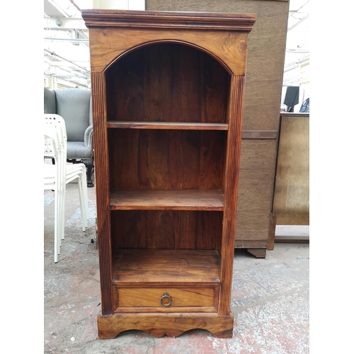 434 - An Indian sheesham wood three tier open bookcase with lower drawer - approx.120cm high x 54cm wide x... 