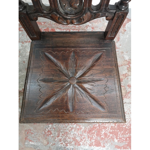 437 - Two 19th century heavily carved oak dining chairs with barley twist design