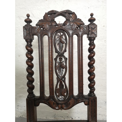 437 - Two 19th century heavily carved oak dining chairs with barley twist design