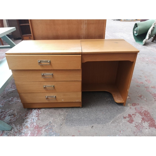 450 - A mid 20th century oak effect two piece bedroom suite comprising dressing table and double wardrobe