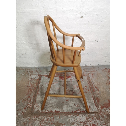 454 - An Ercol style beech child's highchair - approx. 90cm high