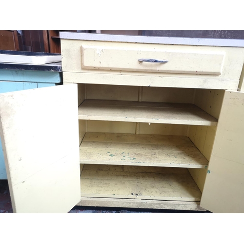 466 - A mid 20th century yellow painted and laminate kitchen cabinet with one drawer and two cupboard door... 