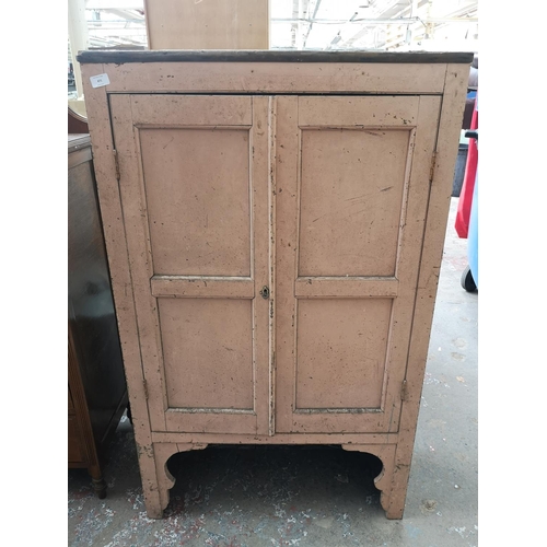 471 - An early 20th century painted pine two door cabinet - approx. 133cm high x 81cm wide x 32cm deep