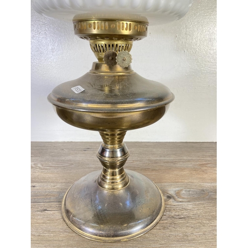 309 - A brass oil lamp with milk glass shade and glass funnel - approx. 54cm high including funnel