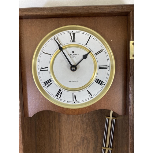 316 - A Junghans quartz Westminster chime wall clock with pendulum - approx. 64cm high x 29cm wide