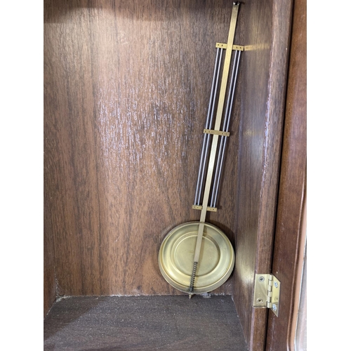 316 - A Junghans quartz Westminster chime wall clock with pendulum - approx. 64cm high x 29cm wide