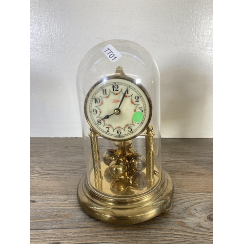 318 - Two German brass anniversary clocks with plastic domes, one being Kundo - largest approx. 23cm high