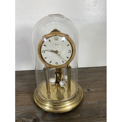 318 - Two German brass anniversary clocks with plastic domes, one being Kundo - largest approx. 23cm high