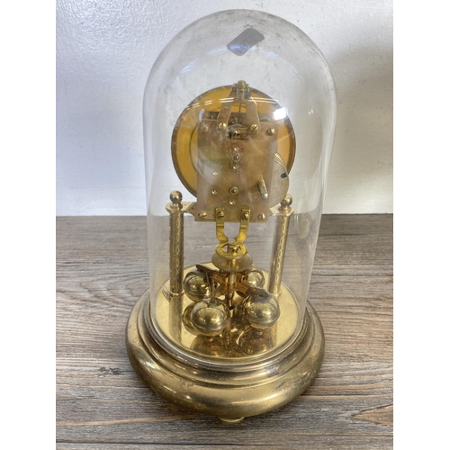 318 - Two German brass anniversary clocks with plastic domes, one being Kundo - largest approx. 23cm high