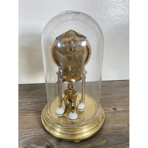 318 - Two German brass anniversary clocks with plastic domes, one being Kundo - largest approx. 23cm high