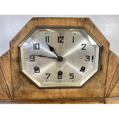 320 - An Art Deco walnut cased chiming mantel clock with pendulum and key - approx. 22cm high x 41cm wide ... 