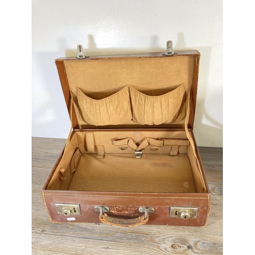 333 - Two items, one early 20th century brown leather suitcase and one wicker fishing basket - approx. 31c... 