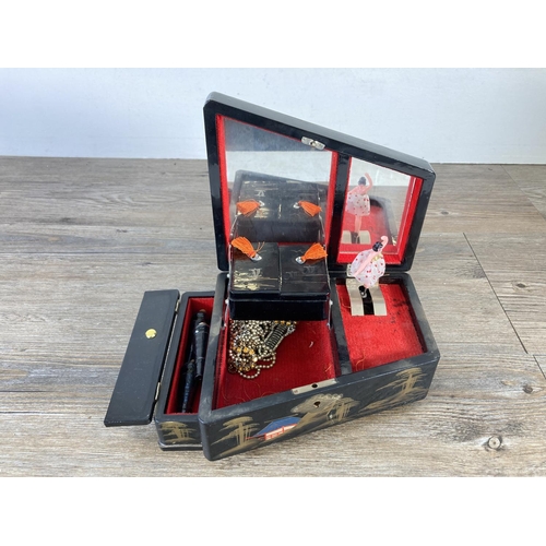 337 - A mid 20th century hand painted and black lacquered novelty grand piano musical jewellery box with t... 