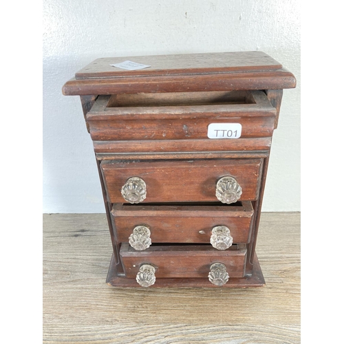 350A - An early 20th century mahogany miniature apprentice chest of three drawers with upper secret drawer ... 