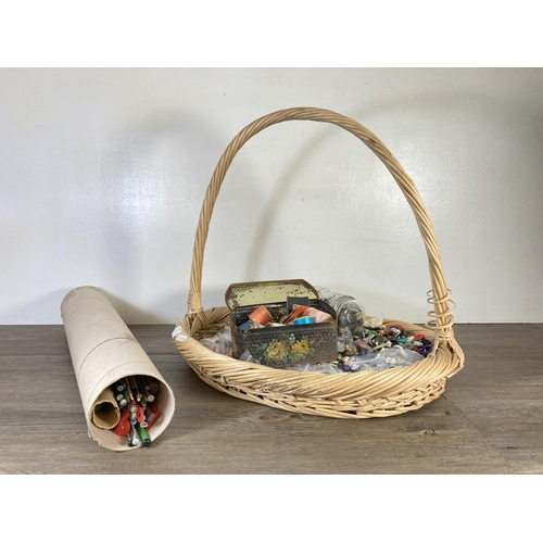 350D - A wicker basket containing haberdashery items to include buttons, thread, knitting pins etc.