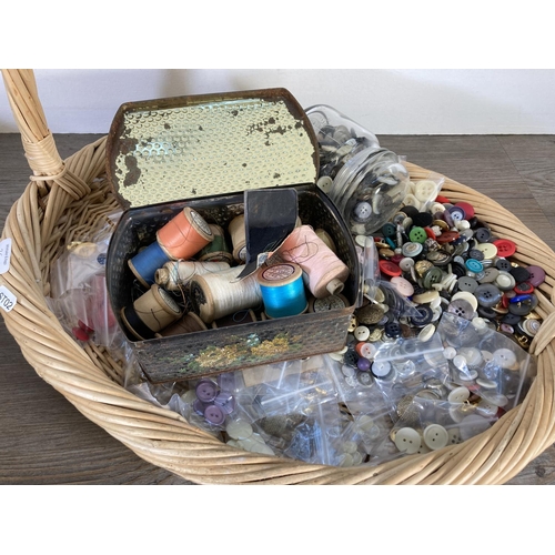 350D - A wicker basket containing haberdashery items to include buttons, thread, knitting pins etc.