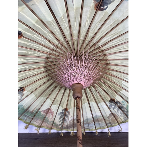 350G - Two oriental hand painted paper and bamboo items, one parasol - approx. 70cm in diameter and one fan... 