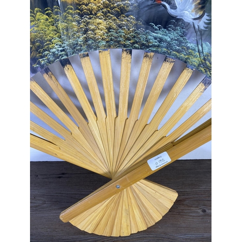 350G - Two oriental hand painted paper and bamboo items, one parasol - approx. 70cm in diameter and one fan... 