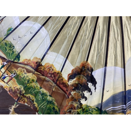 350G - Two oriental hand painted paper and bamboo items, one parasol - approx. 70cm in diameter and one fan... 