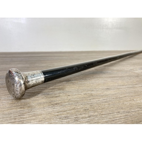 350N - An early 20th century ebonised walking cane with hallmarked Birmingham silver top, dated 1919 - appr... 