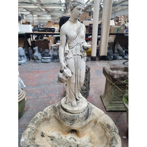 660 - A cast stone garden clamshell and classical lady  birdbath - approx. 102cm high