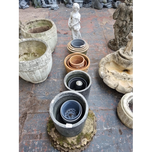 661 - A quantity of garden planters and ornaments to include cast stone tree slice stepping stones, terrac... 