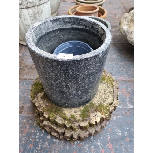 661 - A quantity of garden planters and ornaments to include cast stone tree slice stepping stones, terrac... 