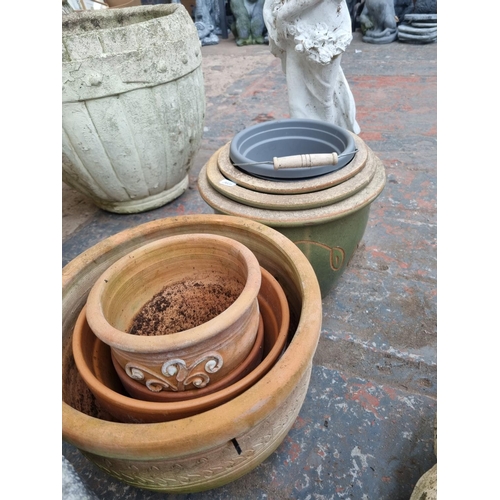 661 - A quantity of garden planters and ornaments to include cast stone tree slice stepping stones, terrac... 