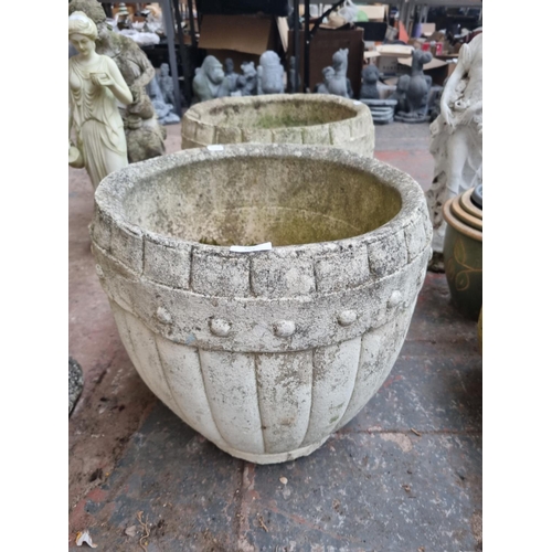 662 - A pair of cast stone barrel type garden planters - approx. 43cm high x 42cm diameter