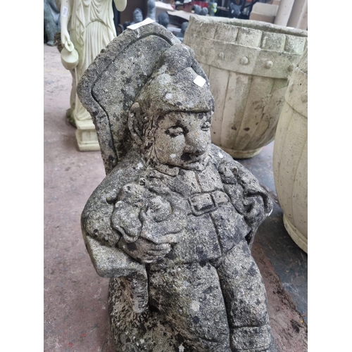 663 - A cast stone seated gnome garden ornament - approx. 42cm high