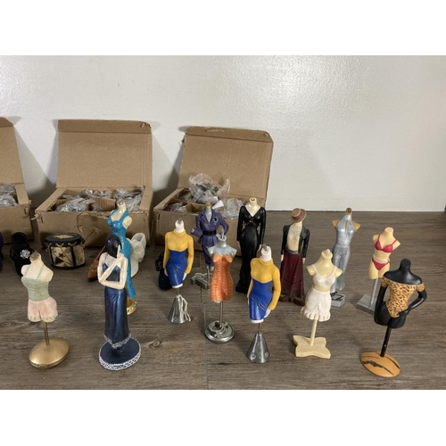 55 - A collection of the Latest Things mannequin figurines and Walton & Co Ltd napkin rings