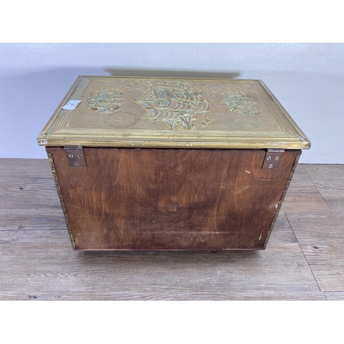 93 - A mid 20th century embossed brass nautical design coal box - approx. 28cm high x 41cm wide x 27cm de... 