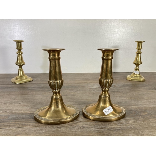 95 - Three pairs of brass candlesticks - largest approx. 17cm high