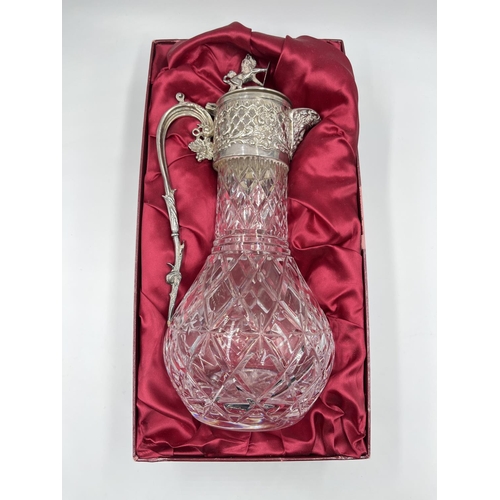 19 - A boxed silver plate and cut glass claret jug - approx. 31cm high