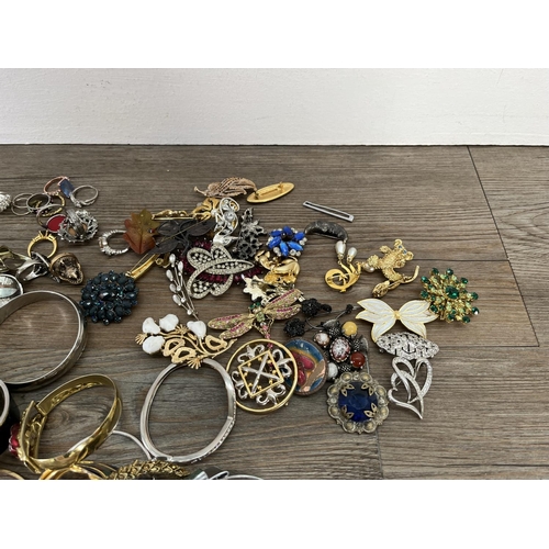 166C - A collection of assorted costume jewellery to include dress rings, brooches etc.