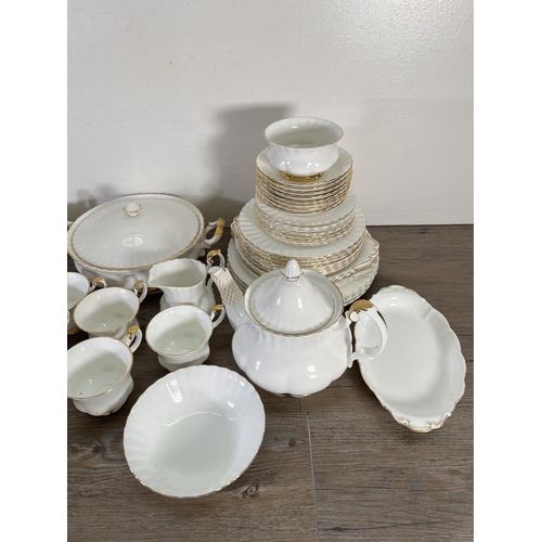 77 - A collection of Royal Albert Val D'or china to include nine cups, teapot, tureen etc.