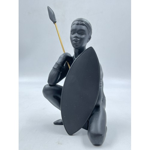 64A - A boxed Bossons African black painted pottery figurine of an African Man - measuring approx. 26cm hi... 