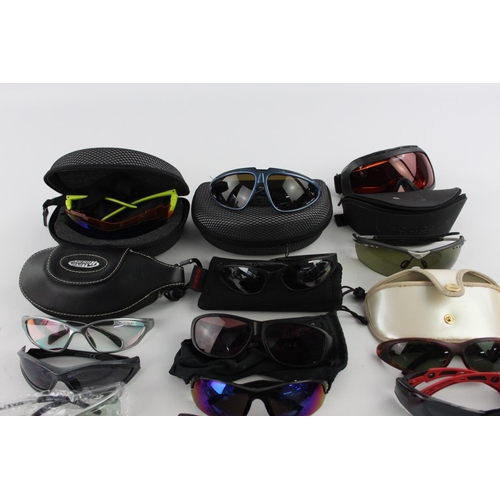 122 - A collection of sports style sunglasses to include BollÃ©, Wind Riders, Police etc.