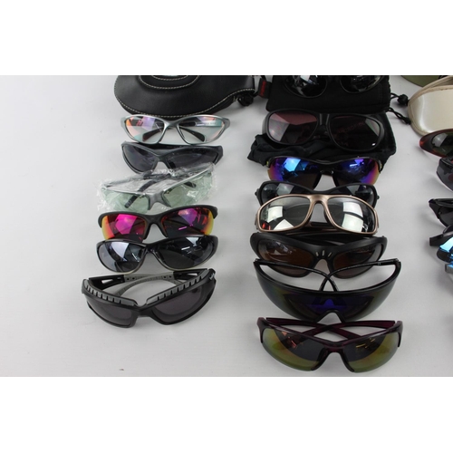 122 - A collection of sports style sunglasses to include BollÃ©, Wind Riders, Police etc.