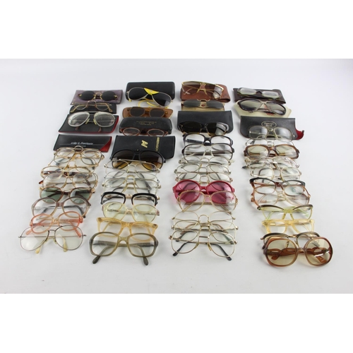 123 - A large collection of glasses and sunglasses to include Polaroid etc.