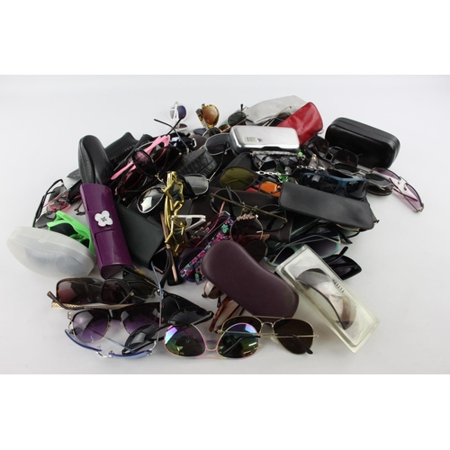 125 - A large collection of sunglasses to include Storm, Foster Grant, Boden etc.