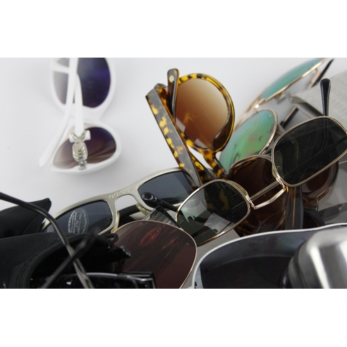 125 - A large collection of sunglasses to include Storm, Foster Grant, Boden etc.