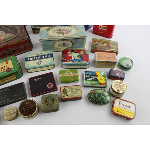 186 - A large collection of vintage tins to include Girl Guides, Cadburys, Pontefract etc.