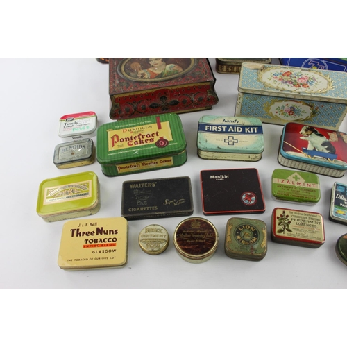 186 - A large collection of vintage tins to include Girl Guides, Cadburys, Pontefract etc.